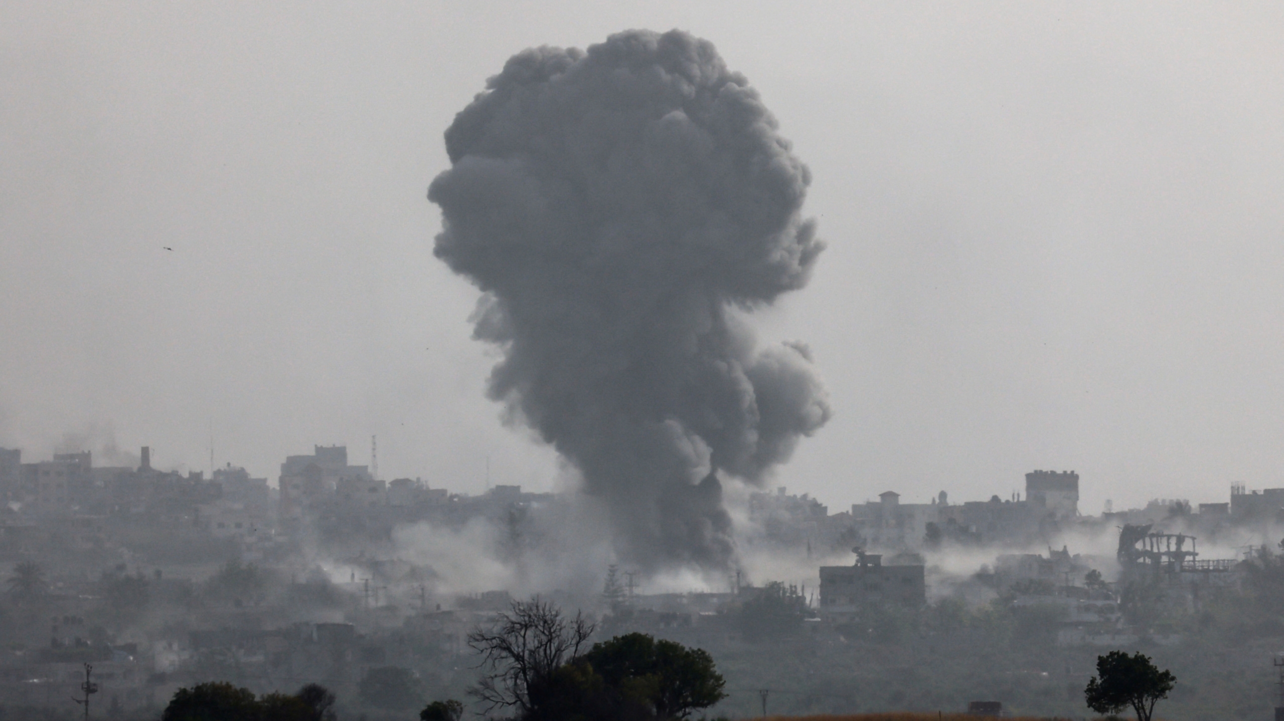 Smoke rises following an Israeli bombing on the Gaza Strip, as seen from Israel on 20 May 2024 (Reuters/Amir Cohen)