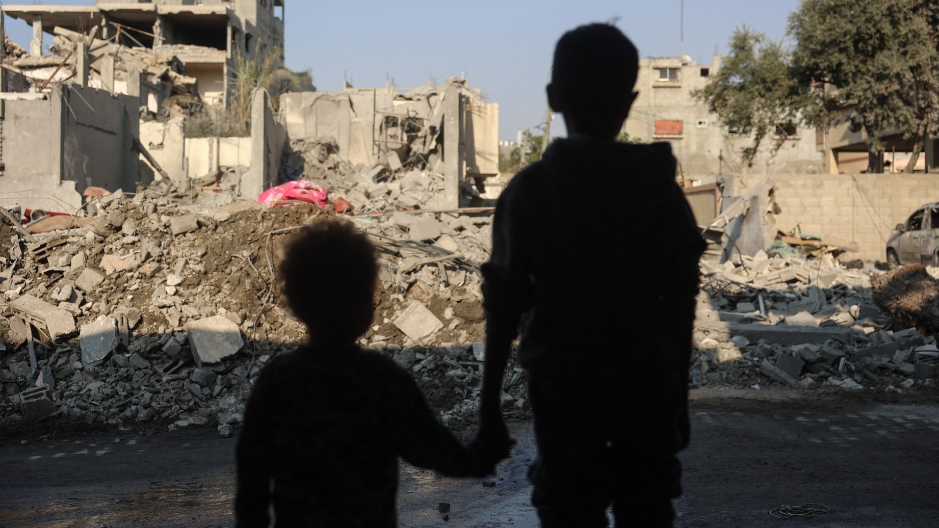 Children stare at the destruction following an Israeli strike in the Nuseirat refugee camp in the central Gaza Strip on 7 November, 2024 (AFP)