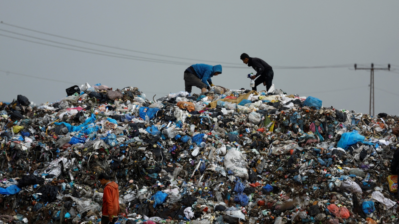 Palestinians look through garbage in Rafah, southern Gaza Strip on 29 January, 2024