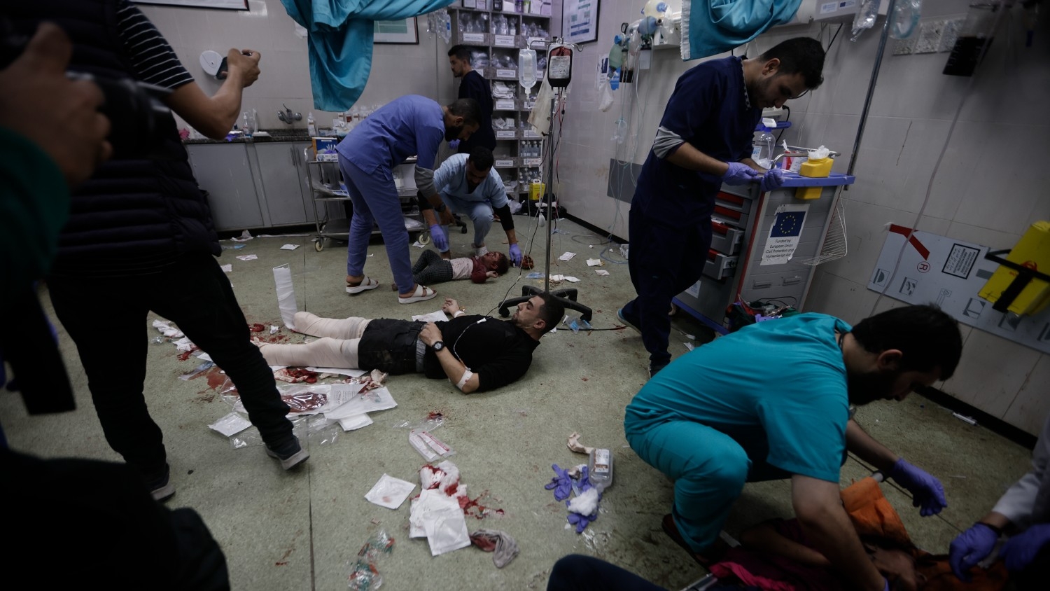Palestinians wounded in the Israeli bombardment of the Gaza Strip are brought to a hospital in central Gaza on 8 December 2023.