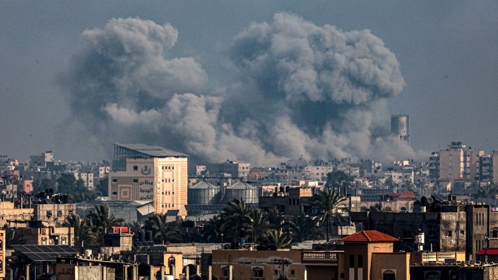 This picture taken from Rafah shows smoke billowing over Khan Yunis in the southern Gaza Strip during Israeli bombardment on 17 January 2024 (AFP)