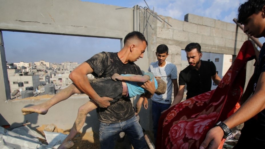 Palestinians carry the body of a victim in the aftermath of an Israeli strike in the Jabalia camp for Palestinian refugees in the Gaza Strip, on 1 November 2023 (AFP)