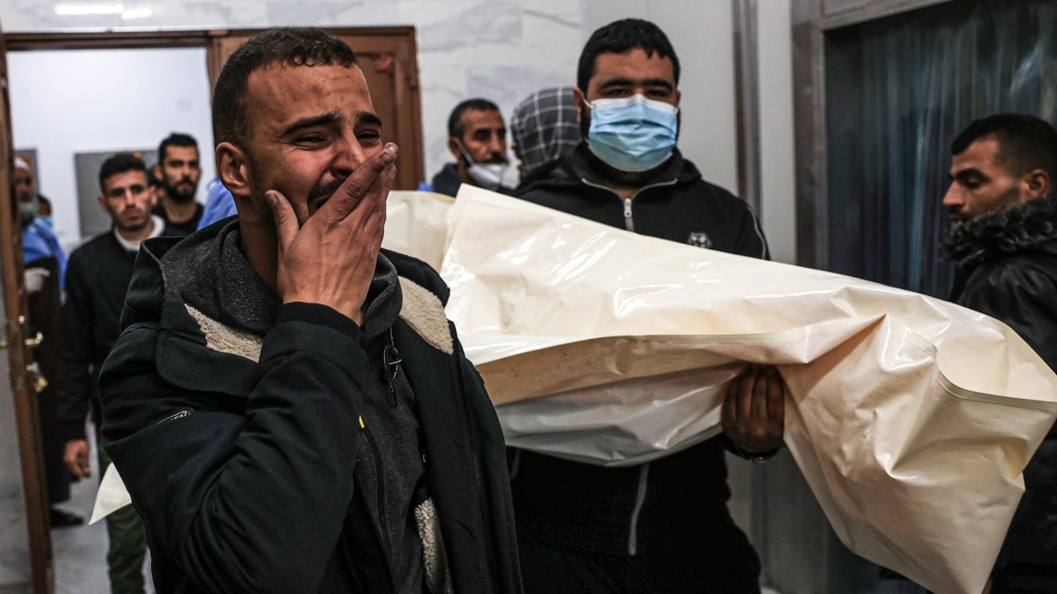Mourners transport a body of Palestinian, killed during an Israeli strike, from the EU hospital in Khan Younis on 21 December 2023, in preparation for their burial in Rafah.