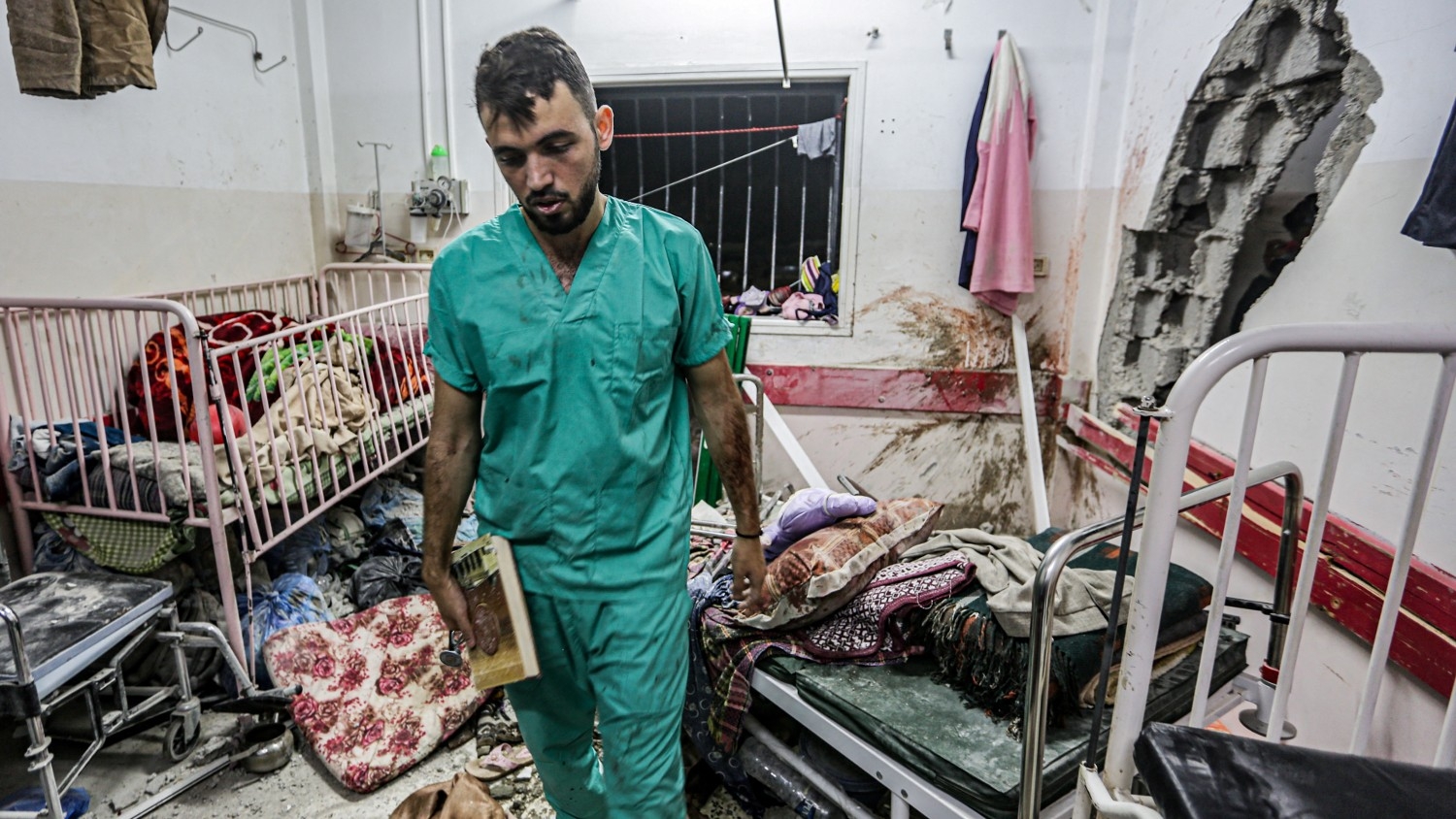 A man inspects the damage in a room following Israeli bombardment at Nasser Hospital in Khan Younis in southern Gaza on 17 December 2023.