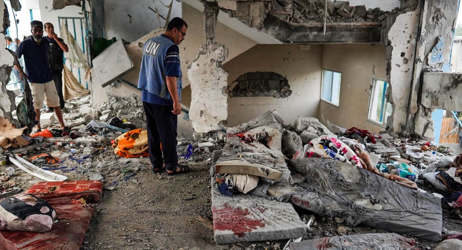 A member of the UN checks a UN-school housing displaced people that was hit during Israeli bombardment in Nuseirat, in central Gaza, on 6 June 2024.