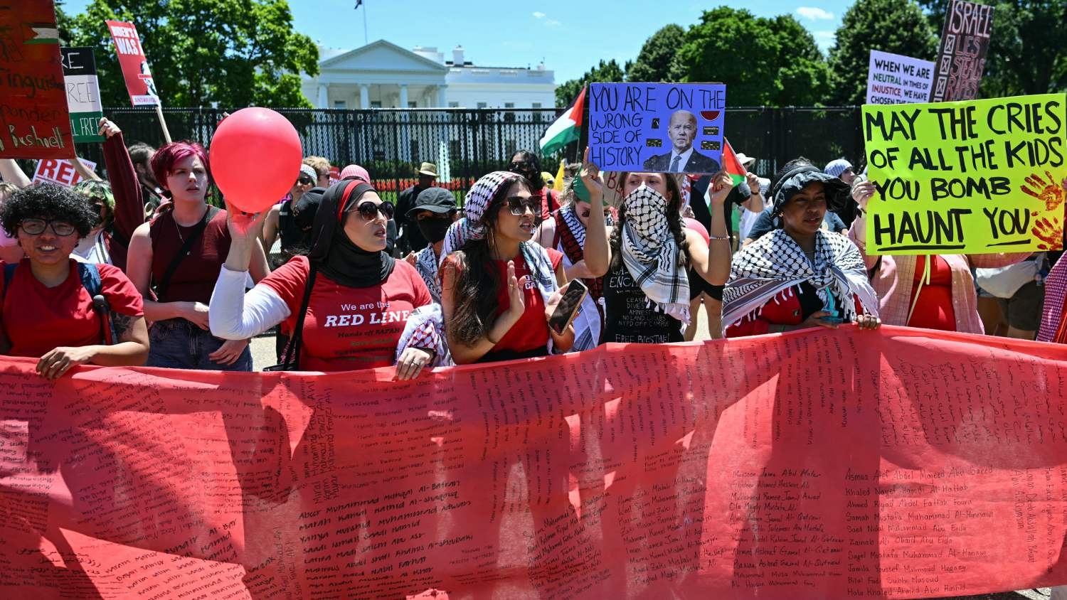 Pro-Palestinian demonstrators, in formation holding a "red line," rally near the White House in Washington, DC, on 8 June 2024 to protest against Israel's actions in Gaza.