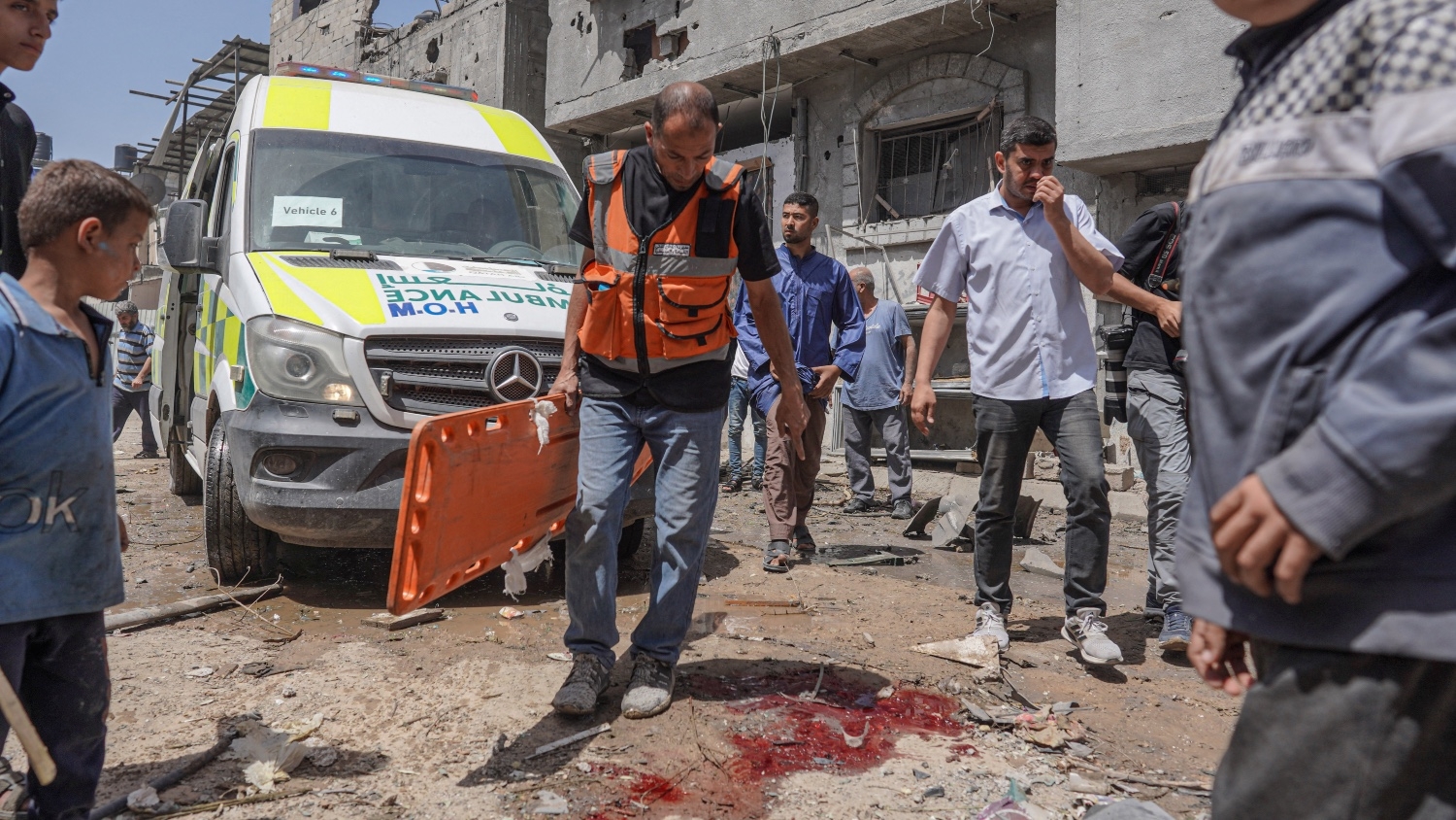 A Palestinian medic arrives at the site of an Israeli strike on al-Bureij camp in the central Gaza Strip on 22 April 2024.