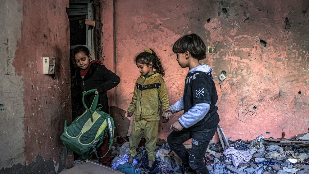 Children in a building damaged by Israeli bombardment in Rafah in the southern Gaza Strip on 24 December 2023 (AFP)