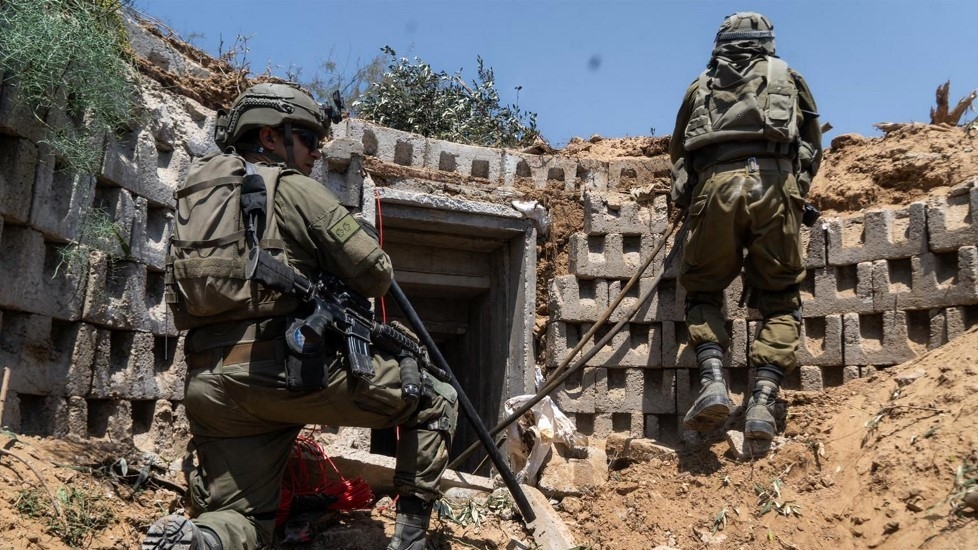 This handout picture released by the Israeli army on 18 April 2024 reportedly shows Israeli soldiers at the entrance of a tunnel in the Gaza Strip (AFP)