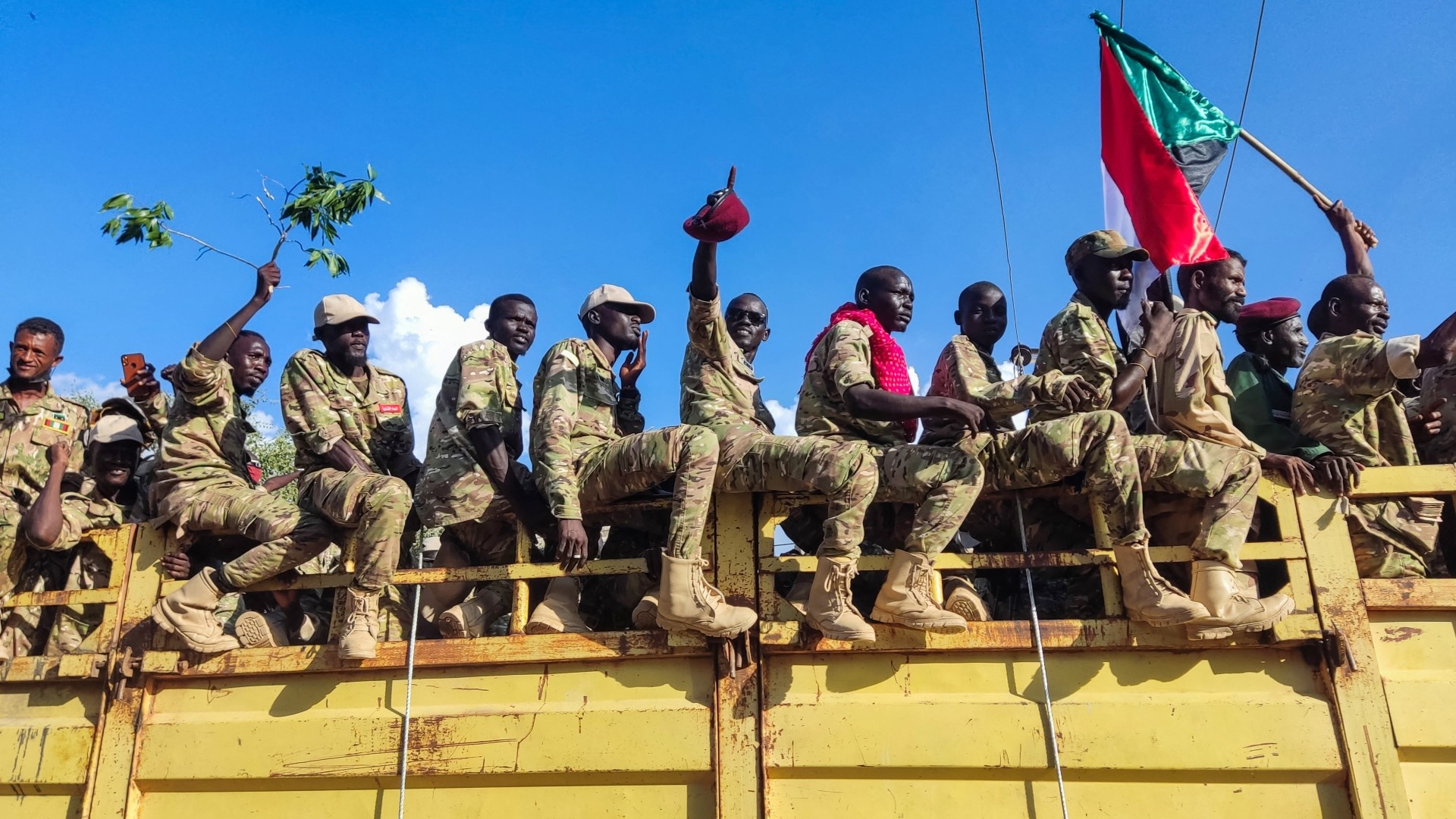 A truck carrying gunmen affiliated with Sudan's army drives on a street in the eastern city of Gedaref on 11 November 2024 (AFP)