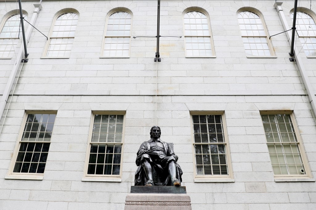 A statue of John Harvard is pictured on the university’s campus in Cambridge, Massachusetts, on 8 July 2020 (AFP)