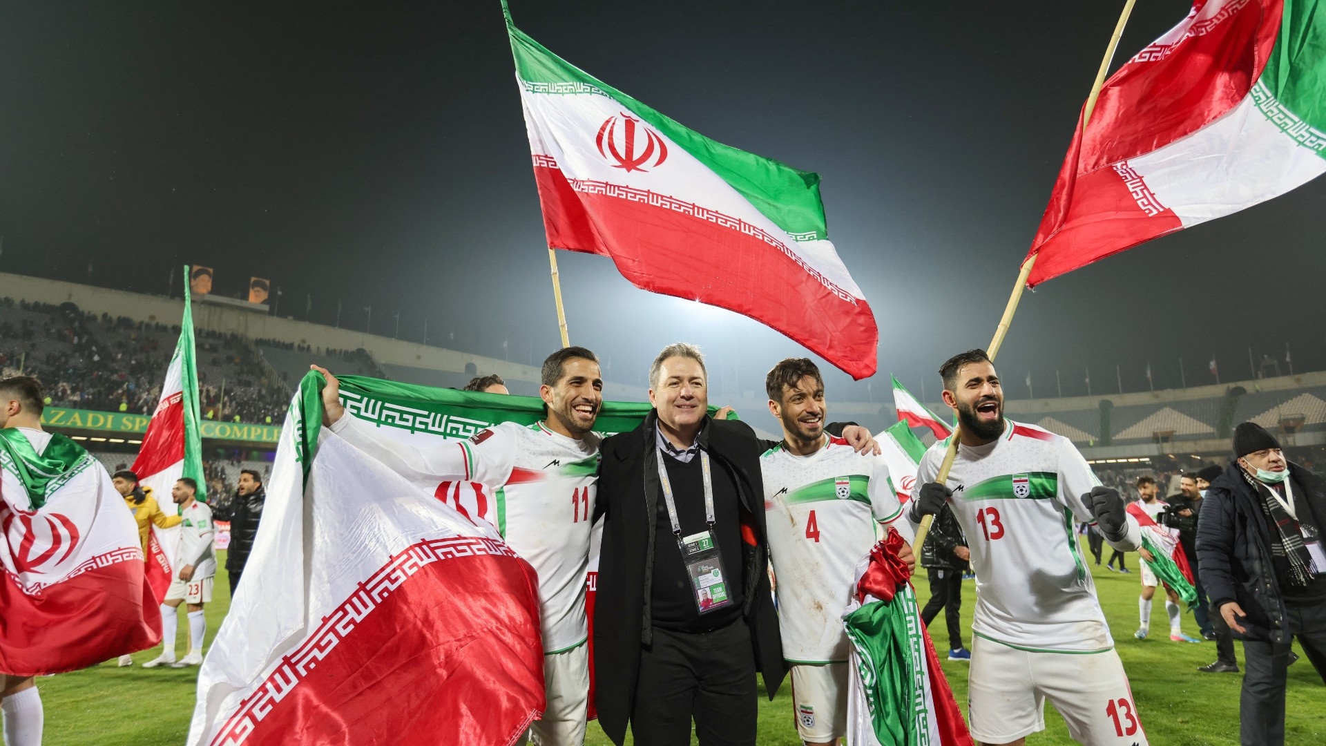 Iran's players celebrate after qualifying for the 2022 Qatar World Cup at the Azadi Sports Complex in the capital Tehran on 27 January 2022 (AFP)