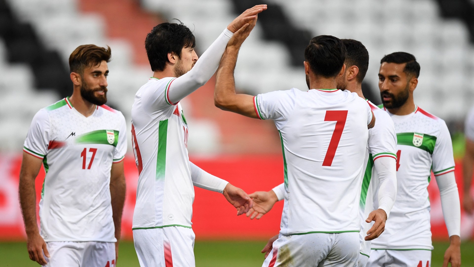 Iran's players celebrate during the friendly football match between Senegal and Iran in Moedling, Austria on 27 September 2022 (AFP)
