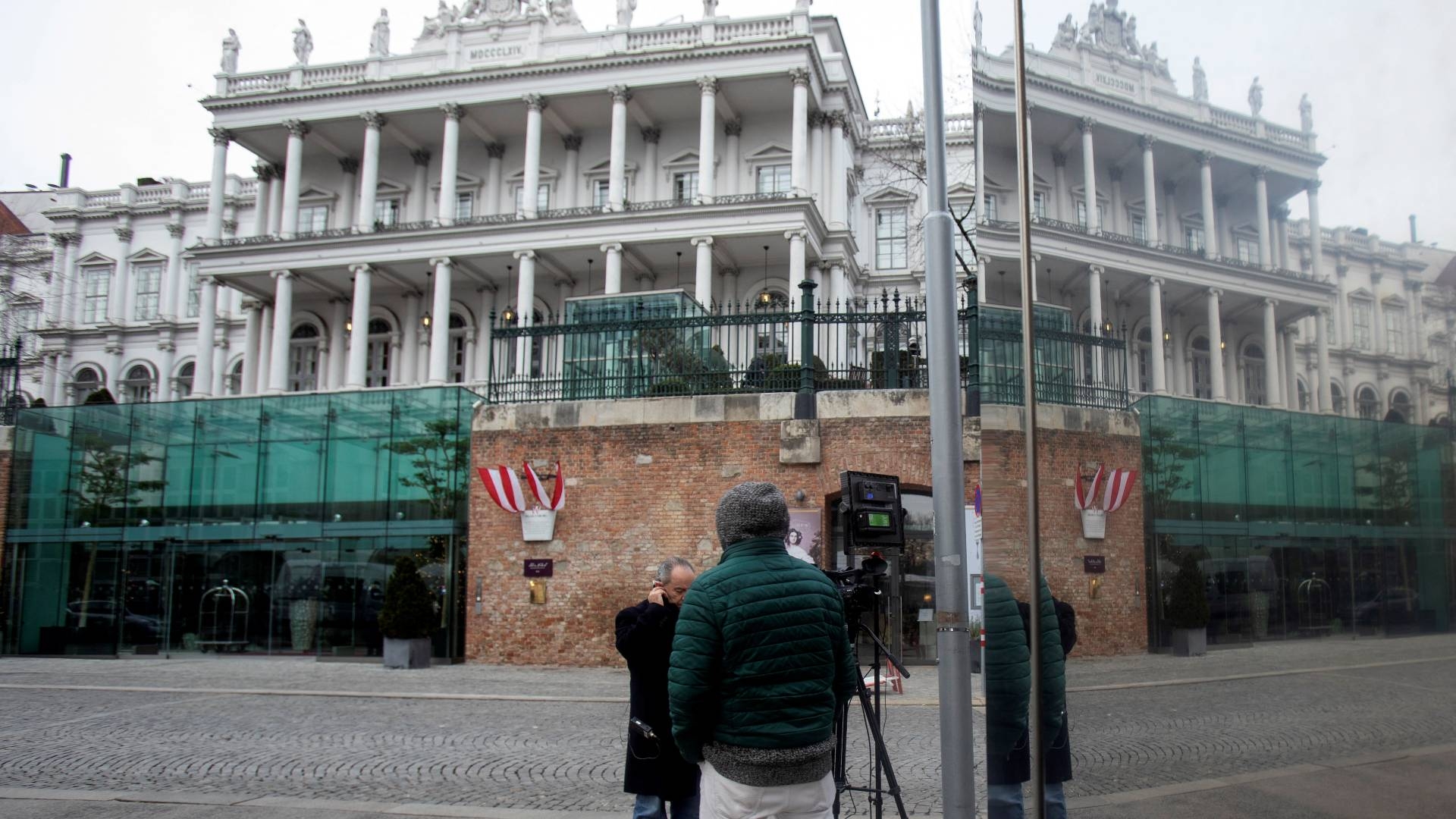 Journalists wait outside the Hotel Palais Coburg, where resumption of talks aimed at reviving the 2015 Iran nuclear deal are taking place in Vienna on 27 December 2021.