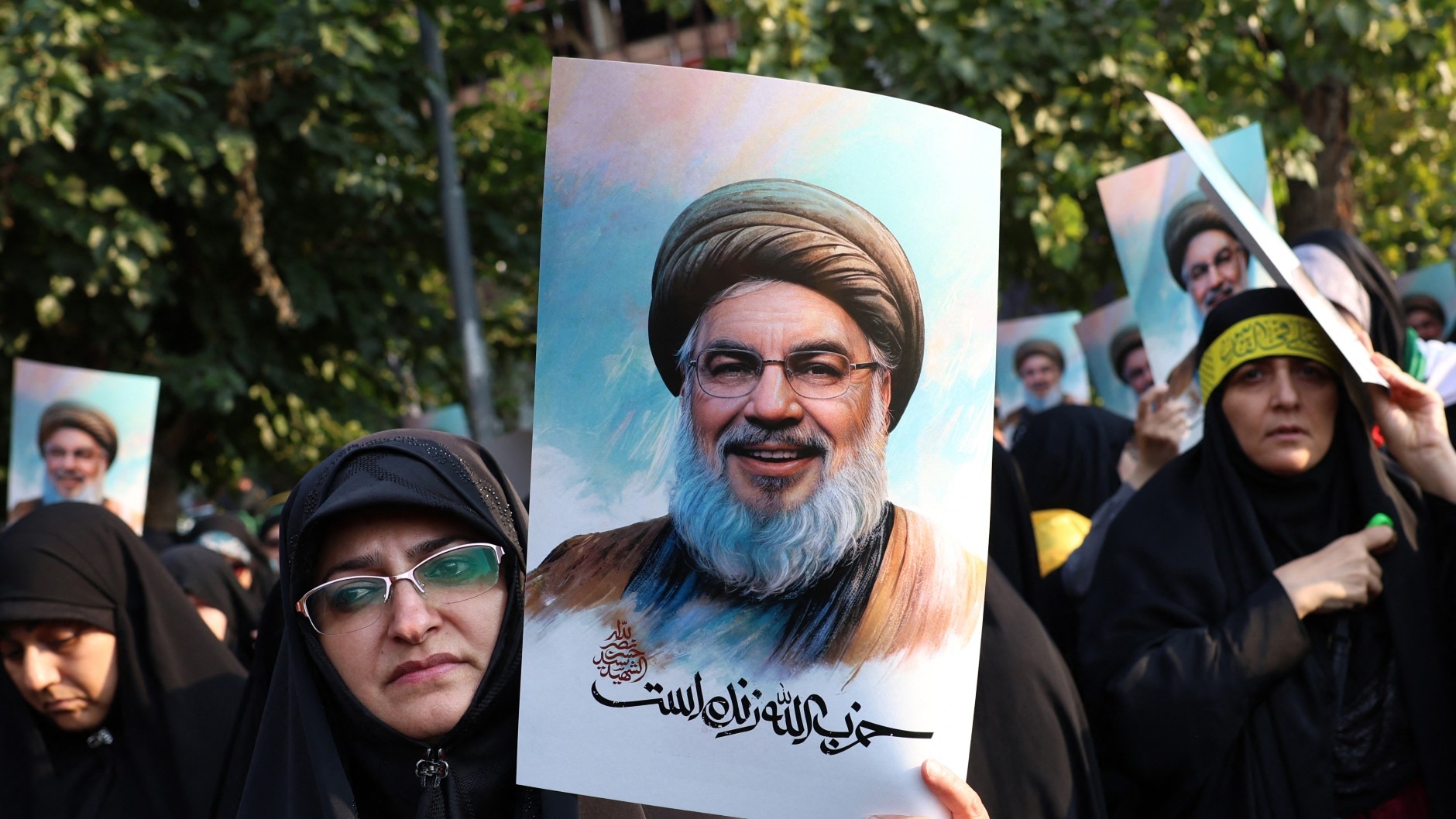 Iranian women hold pictures of Hezbollah leader Hassan Nasrallah during an anti-Israel protest in Tehran's Palestine Square on 30 September, 2024 (Atta Kenare/AFP)