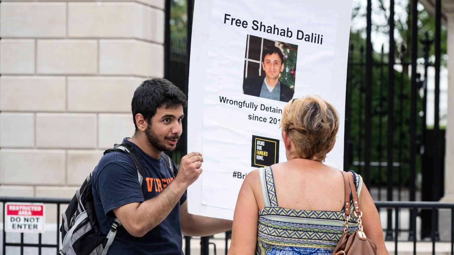 Darian Dalili holds up a sign outside the White House in Washington, DC on 14 August 2023, as he calls for the release of his father, Shahab Dalili, a US permanent resident jailed in Iran.