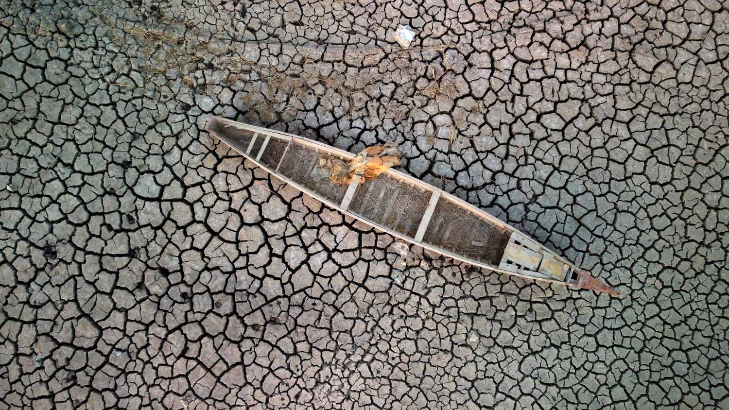 A boat on the dried-up bed of a section of Iraq's receding southern marshes of Chibayish in Dhi Qar province on 24 July 2022.