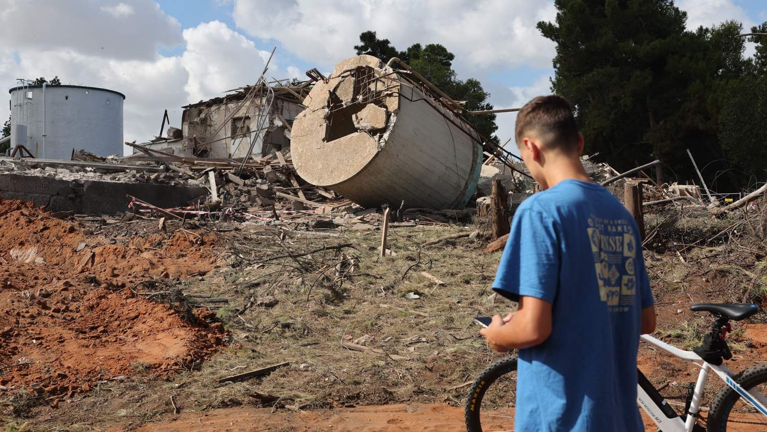 A person checks the rubble of a destroyed building in Hod HaSharon in the aftermath of an Iranian missile attack on Israel, on 2 October 2024.