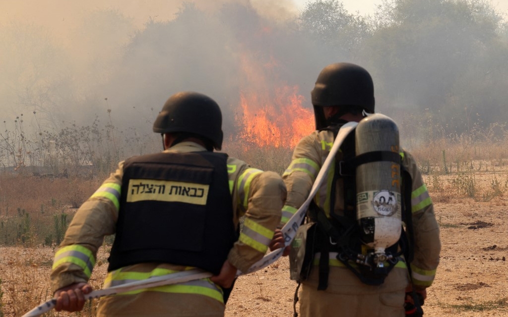 Firefighters deploy to extinguish a blaze after a drone was fired from southern Lebanon near Kfar Dishon in northern Israel on 25 June 2024 (Jack Guez/AFP)