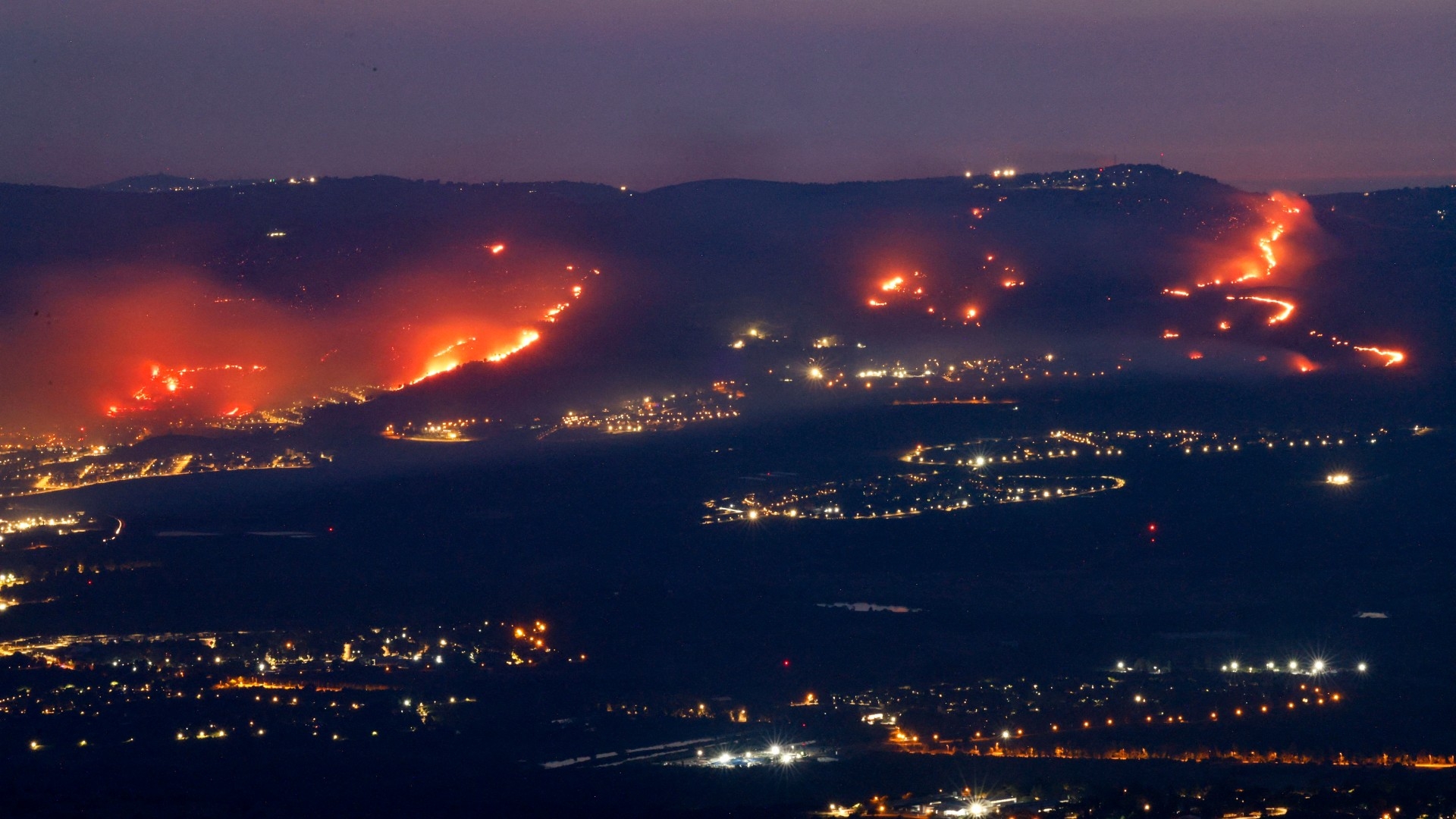 Fires burn in northern Israel, next to the city of Kiryat Shmona near the Lebanon border, on 3 June 2024 (AFP/Jalaa Marey)