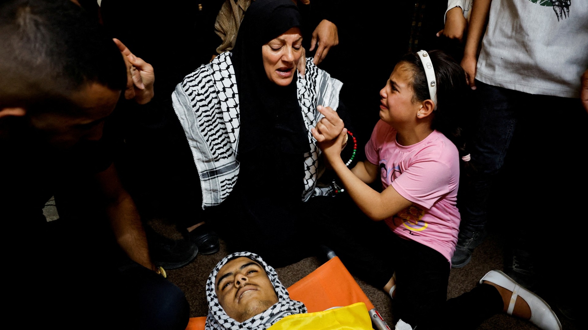 Mourners react during the funeral of a 16-year-old Palestinian teen who was killed by Israeli forces, near Hebron in the Israeli-occupied West Bank 12 October 2023 (Reuters)