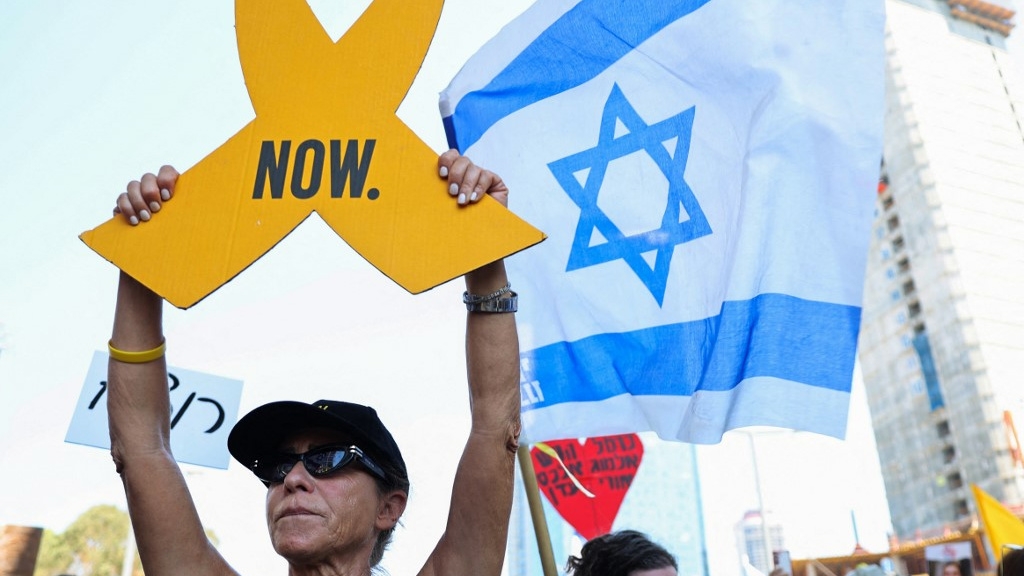 Families and supporters of Israeli hostages block traffic during a rally calling for their release in Tel Aviv on 2 September 2024 (Jack Guez/AFP)