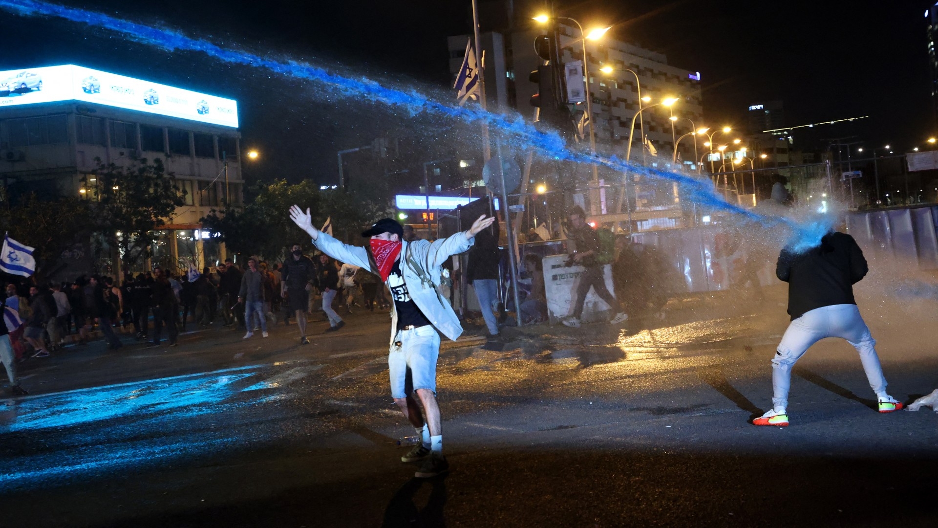 Israeli security forces use water canons to disperse protesters during demonstrations in Tel Aviv on 27 March 2023 (AFP)