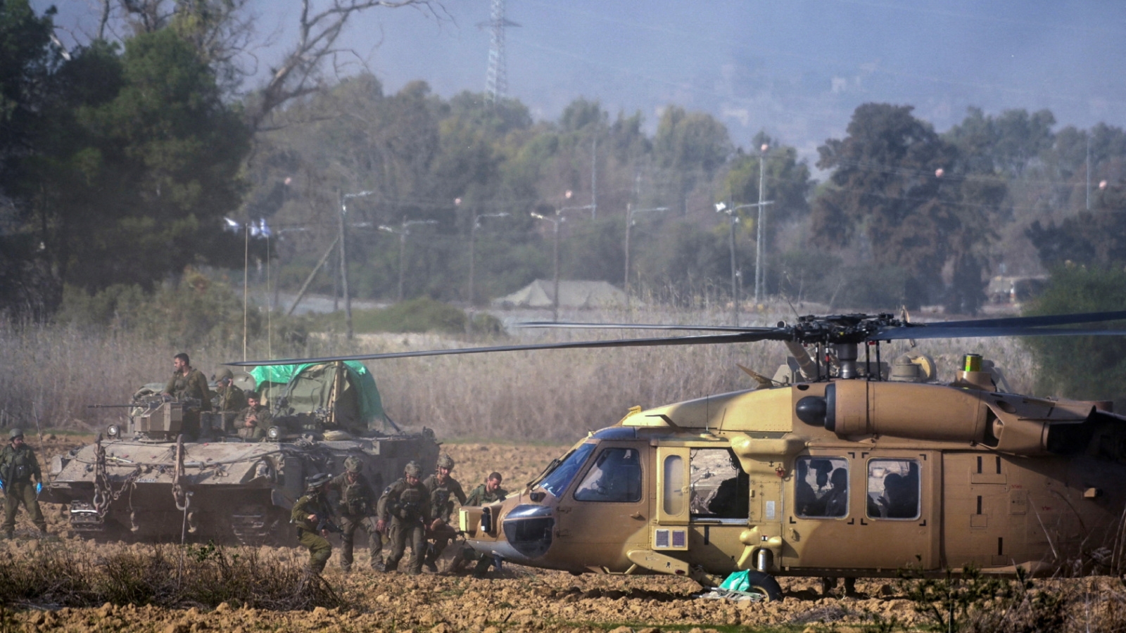 Israeli soldiers carry wounded man near Gaza