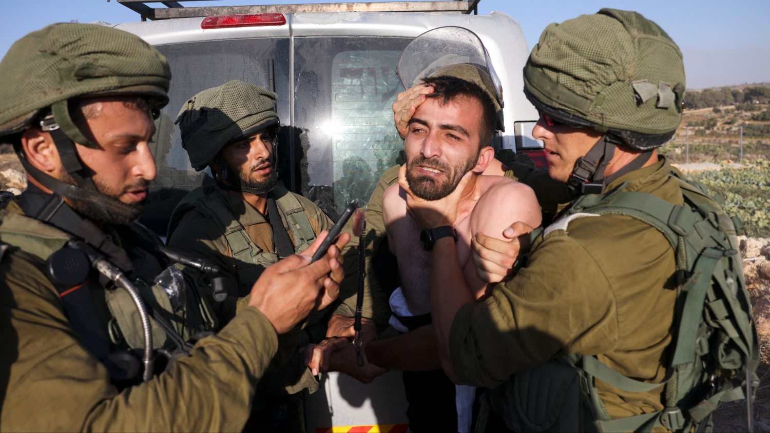 Israeli soldiers clash with Palestinians protesting Israeli settlers (not pictured) who set up tents on lands in Halhoul village north of Hebron in the occupied West Bank, on 1 August 2023.