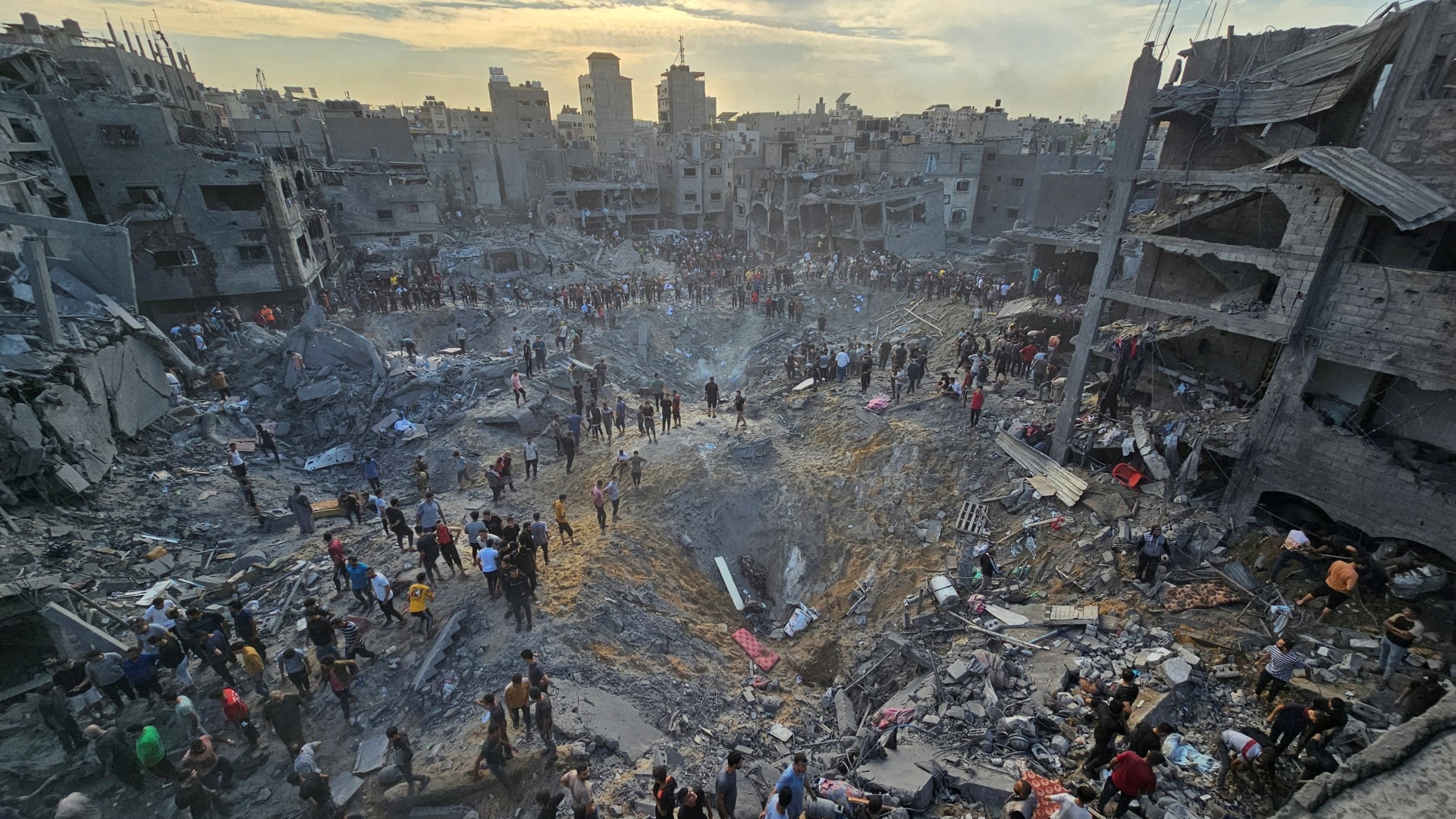 Palestinians search for casualties at the site of Israeli strikes on houses in Jabalia refugee camp in the northern Gaza Strip on 31 October 2023 (Reuters) 