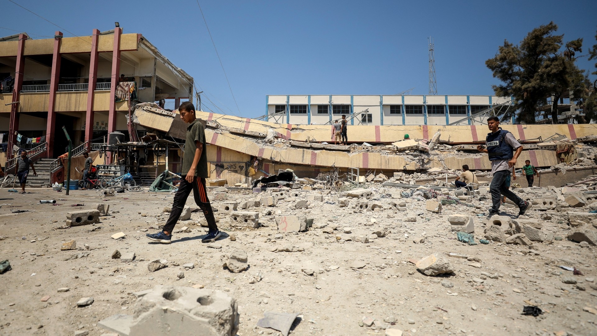 Palestinians inspect a school sheltering displaced people after it was hit by an Israeli strike in Gaza City on 20 August 2024 (Reuters/Dawoud Abu Alkas)