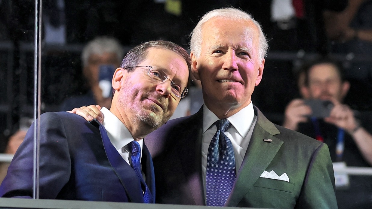 US President Joe Biden embraces his Israeli counterpart Isaac Herzog during the opening ceremony of the Maccabiah Games at Teddy Stadium in Jerusalem on 14 July 2022.