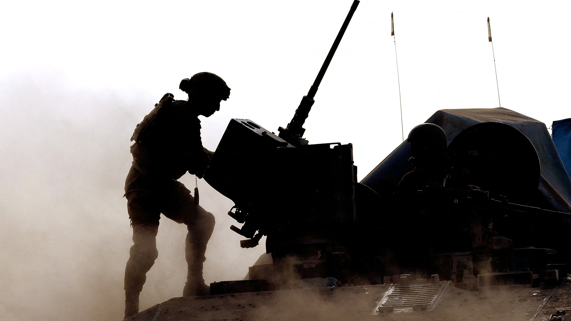 An Israeli soldier stands atop a military vehicle in southern Israel near the boundary with the Gaza Strip on 29 May (Jack Guez/AFP)