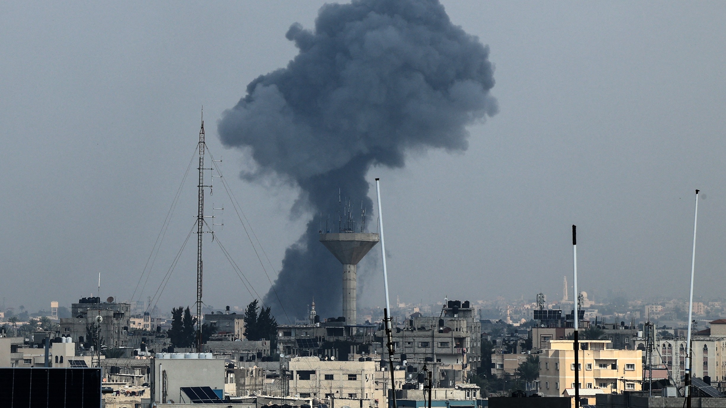 Smoke rises above buildings during an Israeli strike on Rafah in the southern Gaza Strip on 1 December 2023 (AFP)