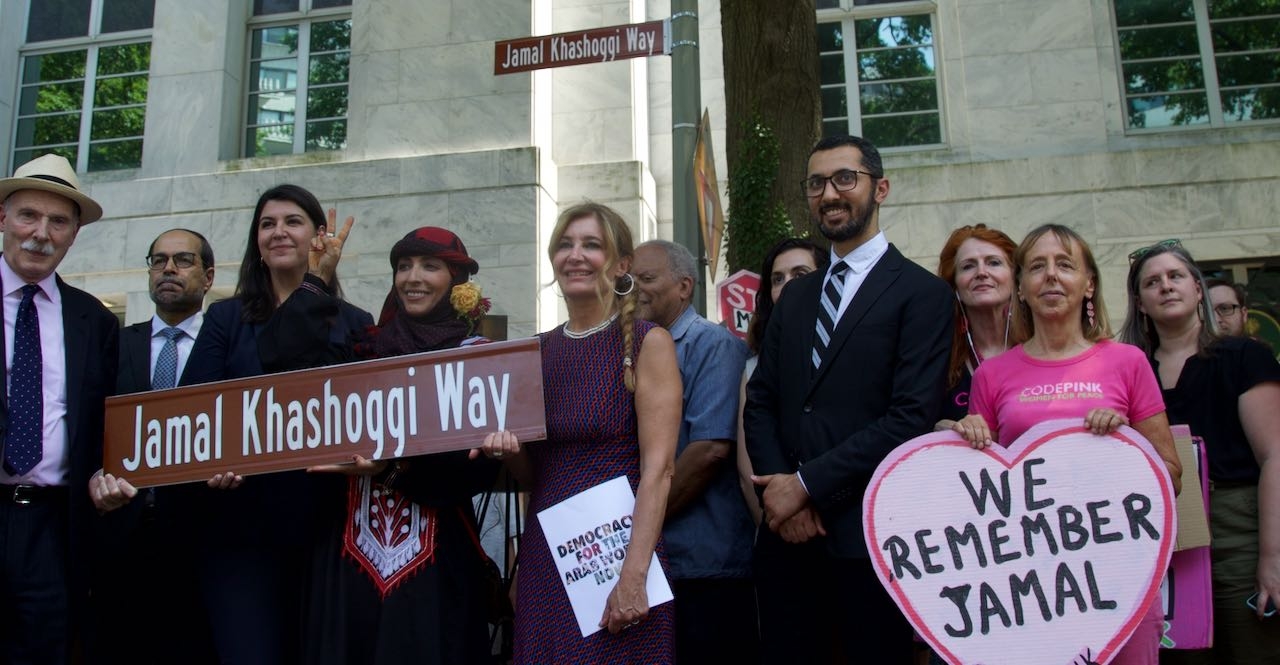 Activists gather around the new "Jamal Khashoggi Way" street sign after the renaming ceremony outside the Saudi embassy in Washington on 15 June 2022.