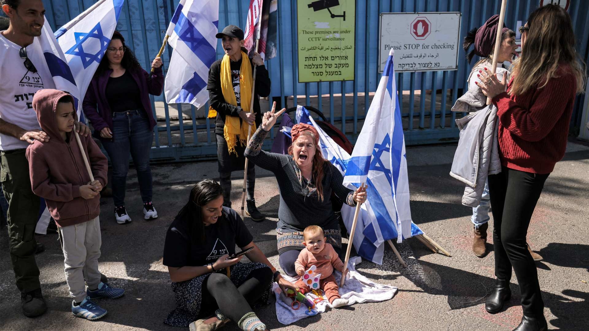 Right-wing Israeli protesters gather with flags and banners outside the West Bank field office of Unrwa in Jerusalem on 20 March 2024.