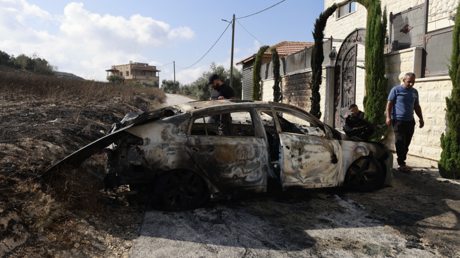 Palestinians inspect a burnt car following a deadly settler attack on Jit, occupied West Bank on 16 August 2024 (Jaafar Ashtiyeh/AFP)