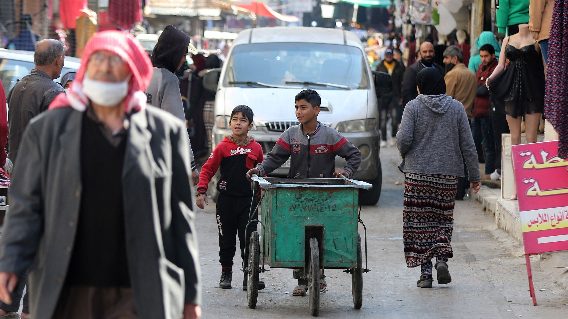Jordanian youths use a hand cart in Amman's Wahdat district on 10 January 2021 (AFP)