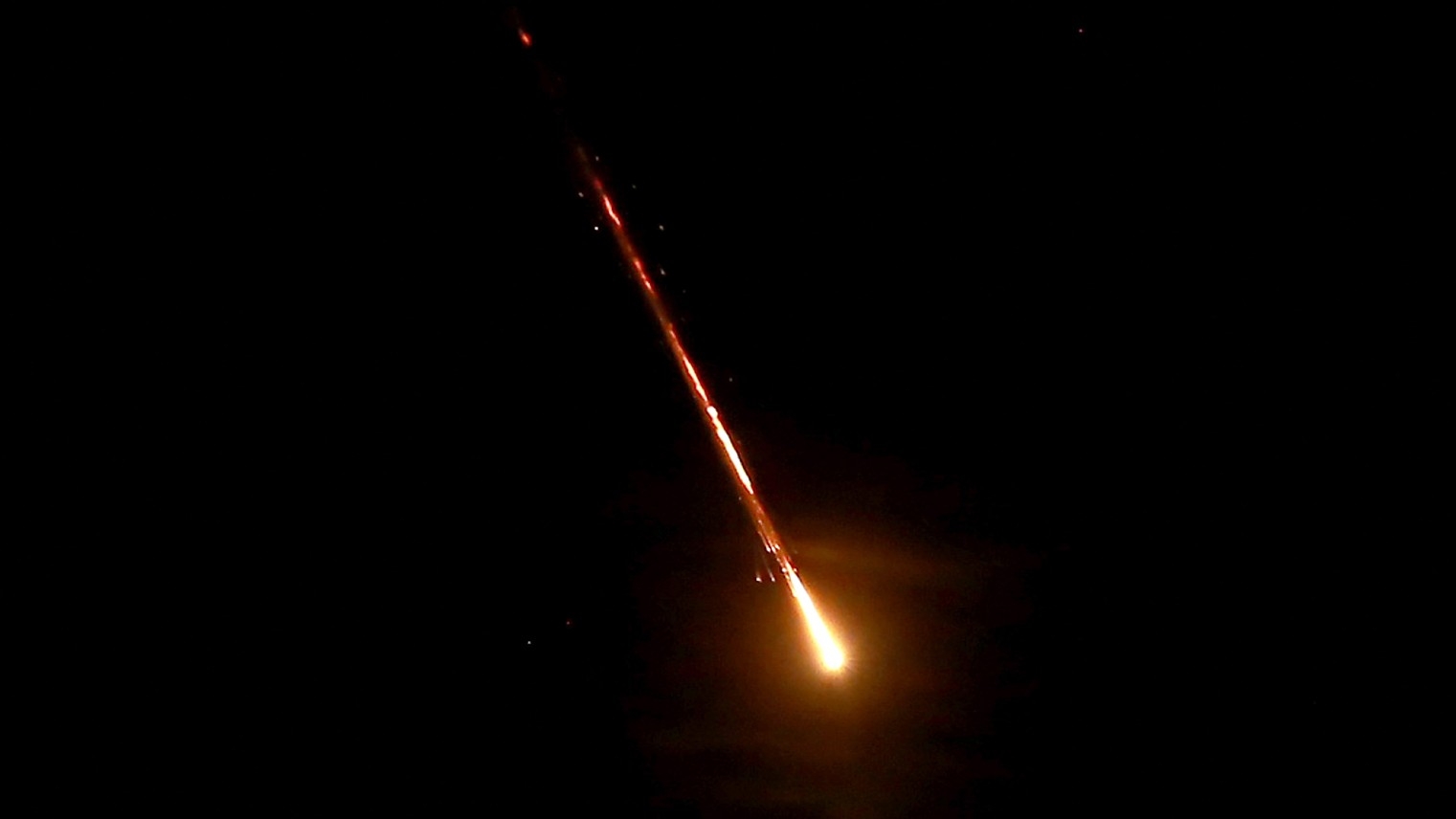 This picture shows a projectile flying above the Jordanian capital Amman towards Israel, on 1 October, 2024 (Khalil Mazraawi/AFP)