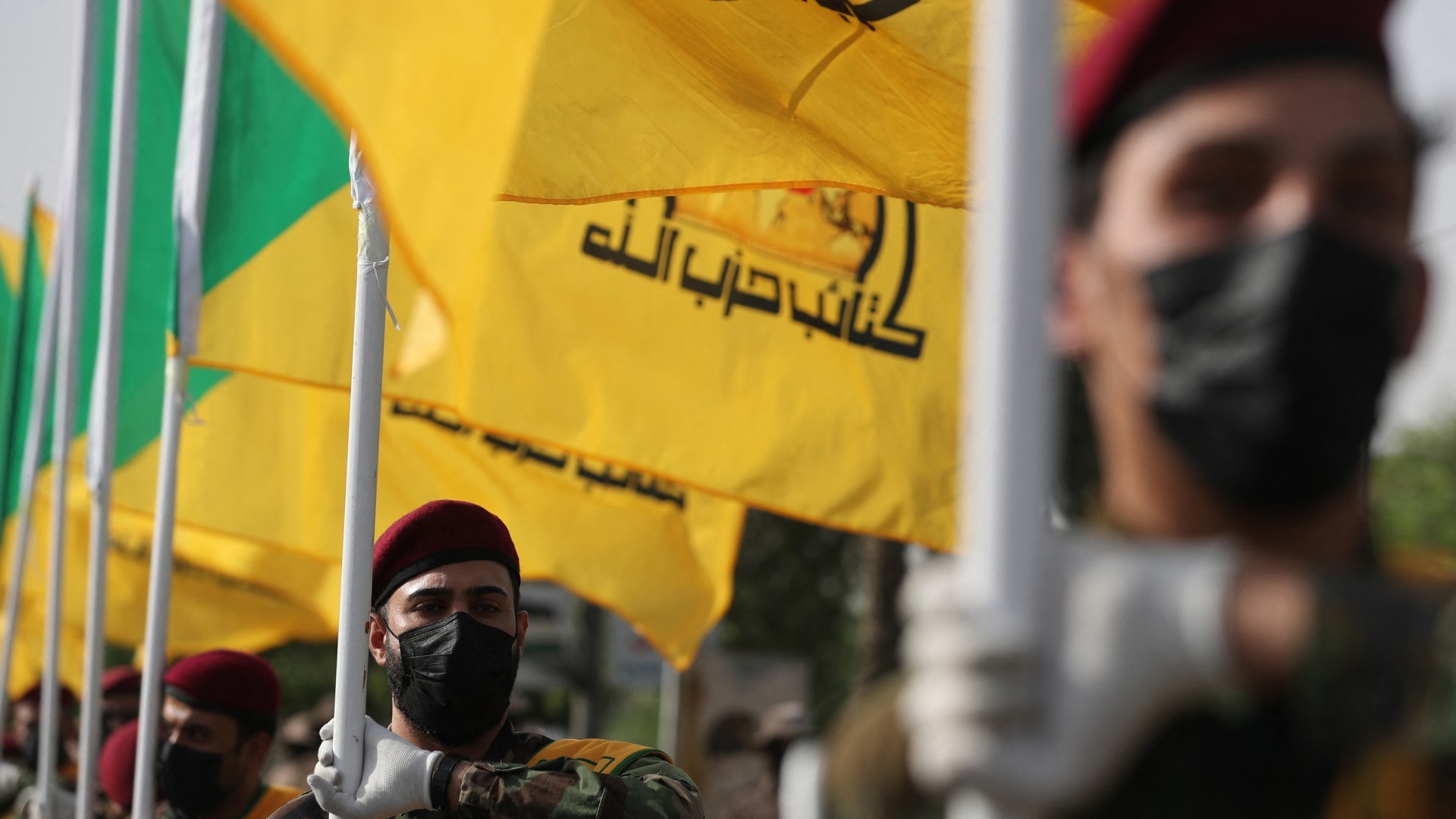 Members of Iraq's Kataeb Hezbollah attend the funeral of a commander in Baghdad on 22 September 2024 (AFP/Ahmad al-Rubaye)