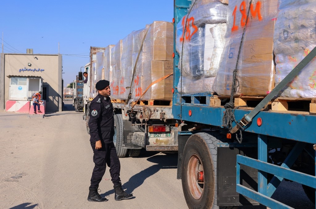 A Palestinian police officer searches a truck slated for export at the Kerem Shalom crossing in the southern Gaza Strip on 21 June 2021.