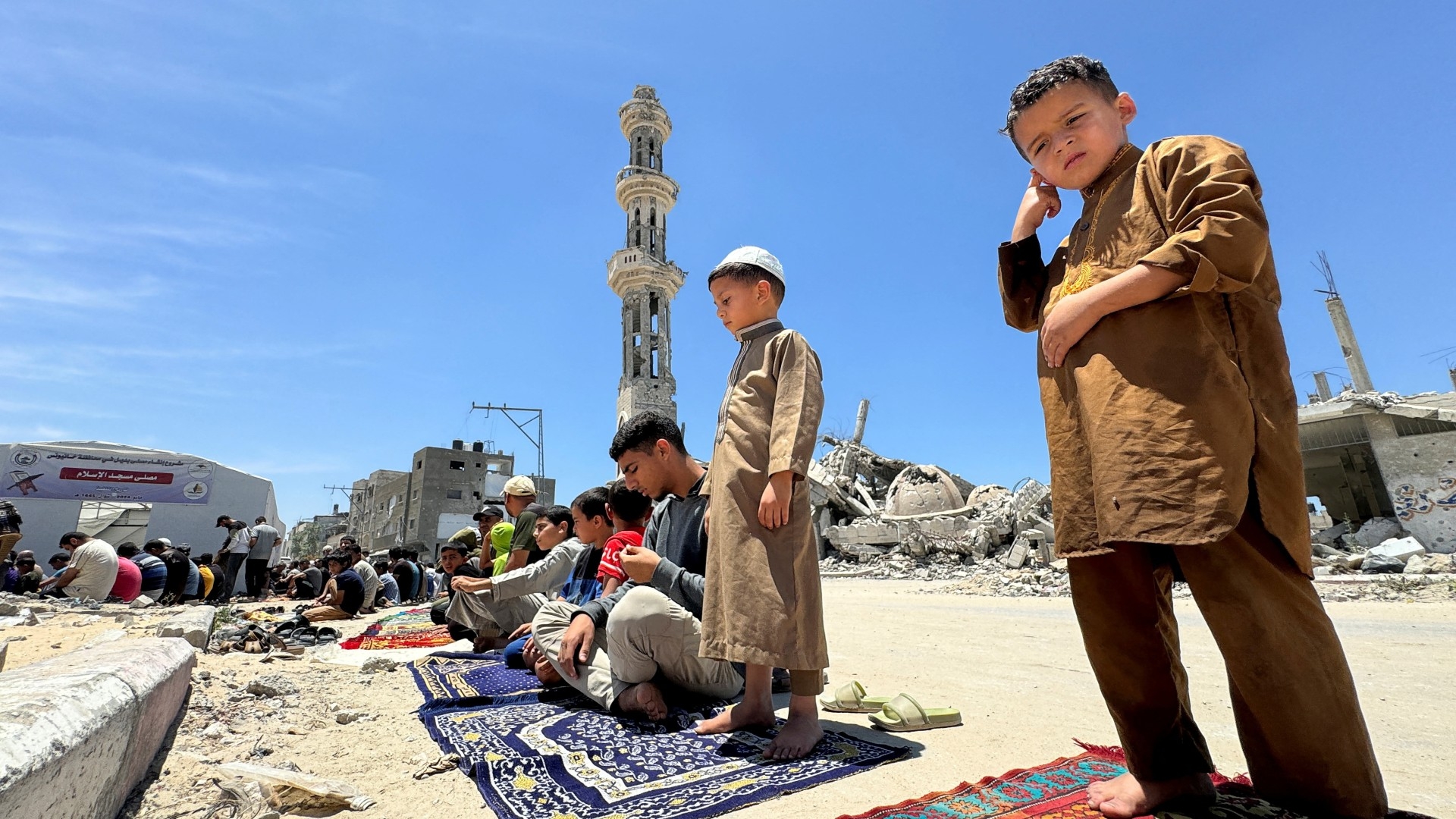 Palestinians perform Friday prayers at the ruins of a mosque destroyed in the Israeli military offensive in Khan Younis, 31 May (Reuters/Mohammed Salem)