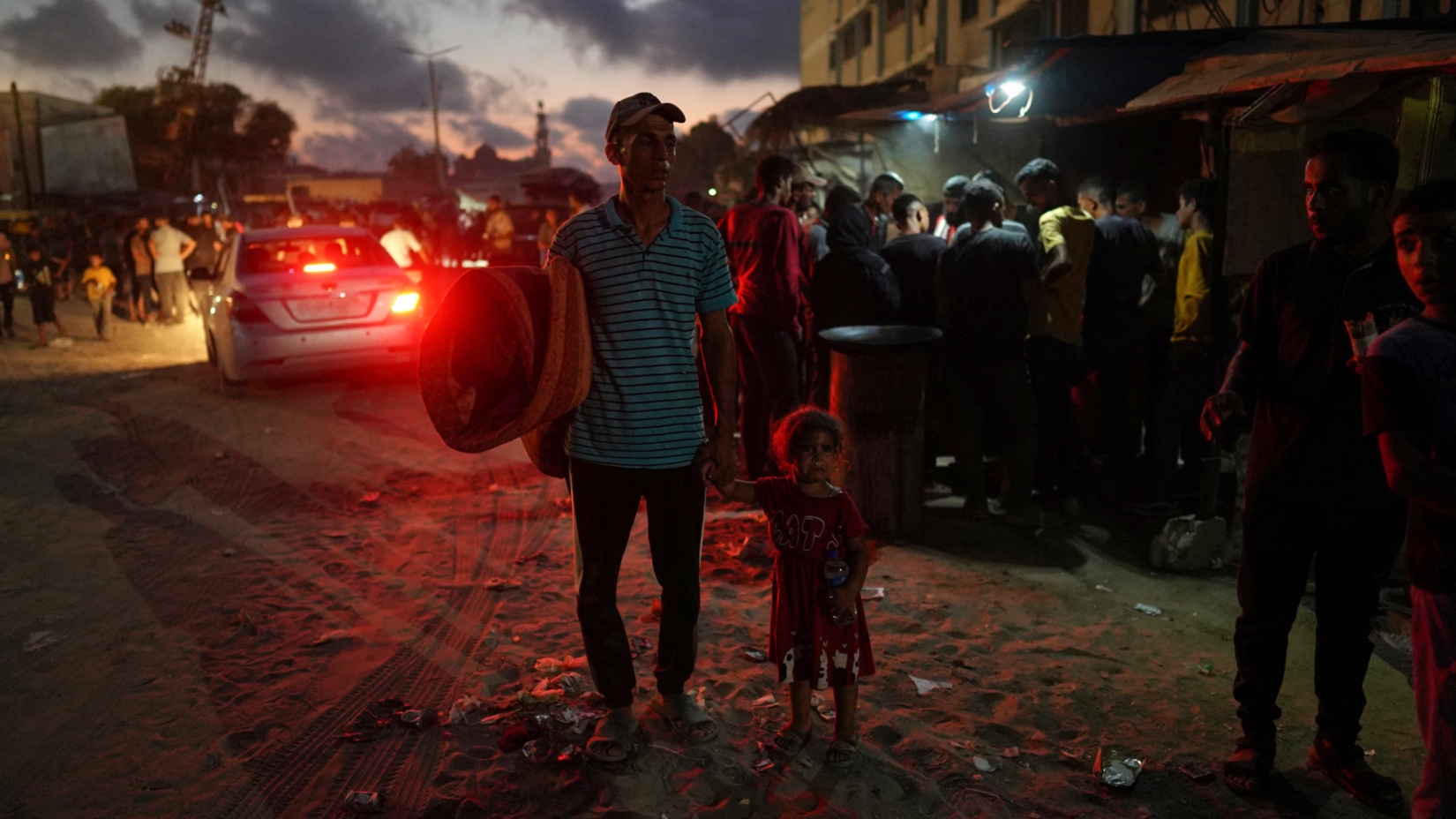 Displaced Palestinians leave an area east of Khan Younis following evacuation orders from Israel on 22 July 2024 (Bashar Taleb/AFP)