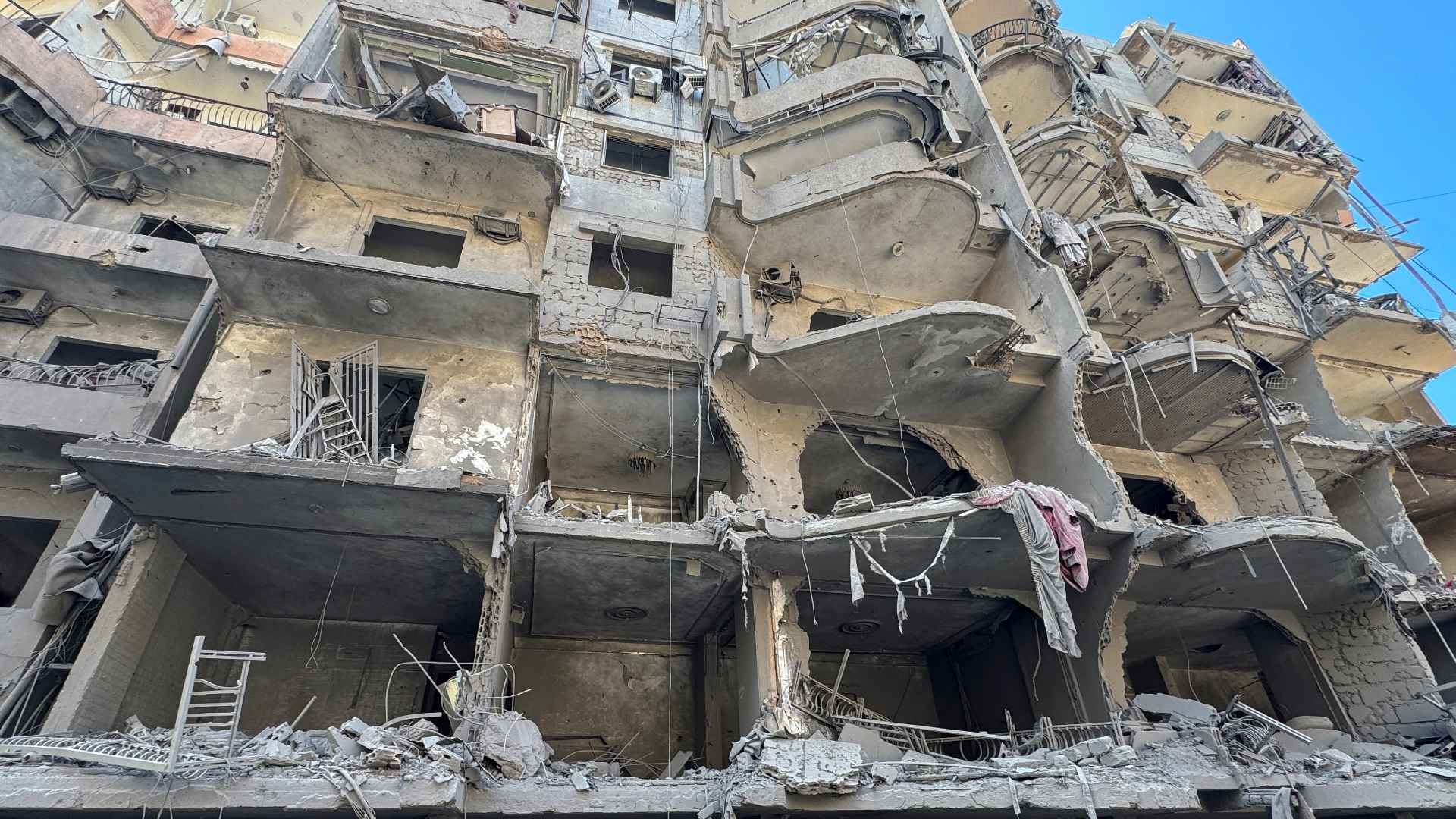 Damaged buildings in Beirut at the scene of an air strike which killed Hassan Nasrallah on 27 September 2024 (Ahmad Al-Kerdi/Reuters)