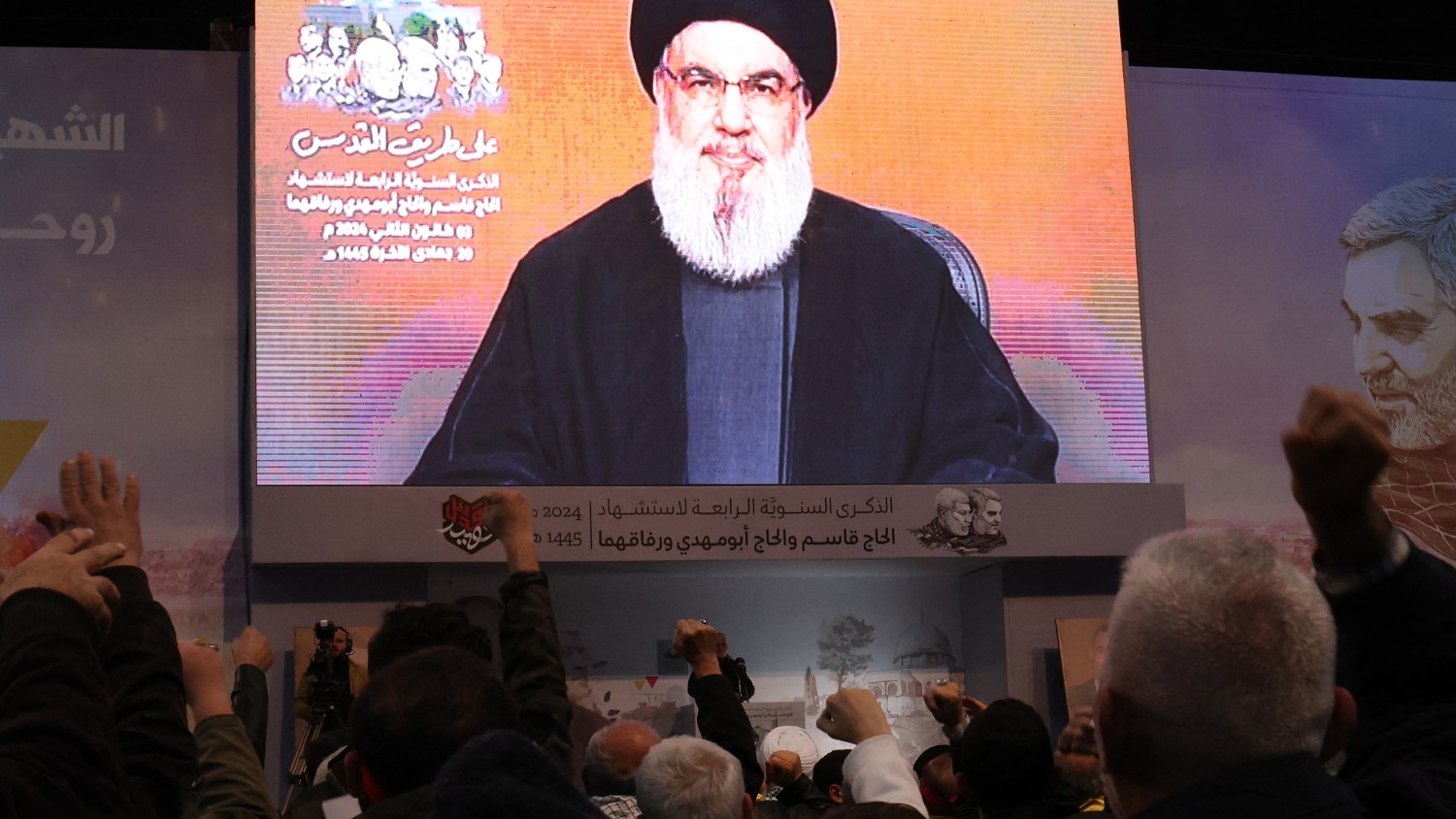 People watch the televised speech of Lebanon's Hezbollah chief Hassan Nasrallah to mark the anniversary of the killing of slain top Iranian commander Qassem Soleimani, in Beirut on 3 January 2024.