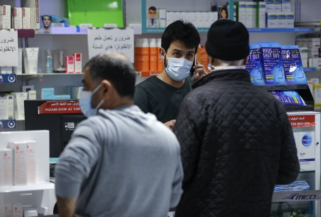 Customers buy medicine at a pharmacy in the Lebanese capital Beirut, on 2 February 2021.