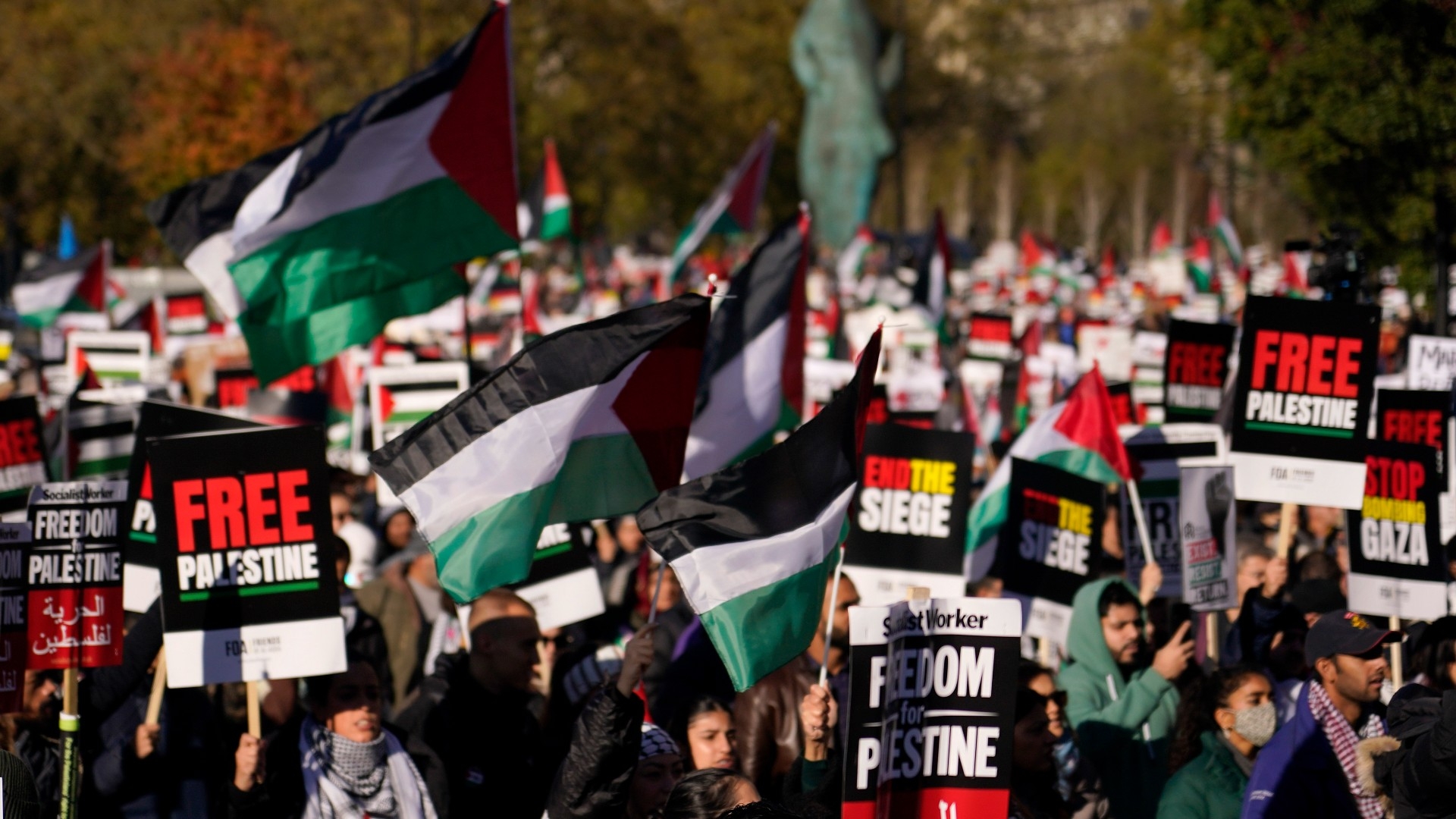 Protesters show placards during a pro-Palestinian protest in London, Saturday, Nov. 11, 2023.  AP