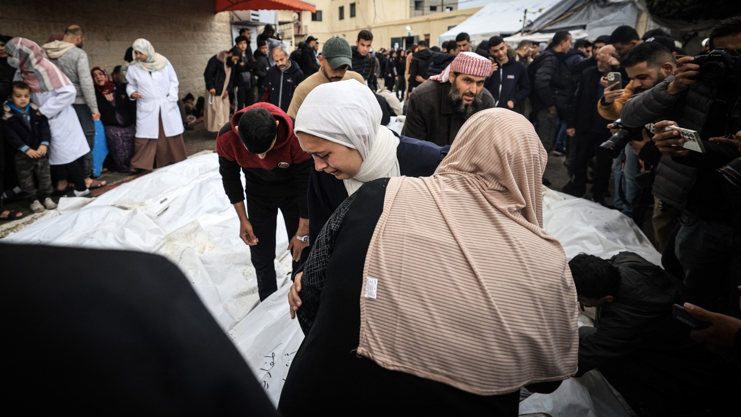 Palestinians mourn those killed in an Israeli strike on Maghazi refugee camp in Gaza on Christmas Eve (AFP/Mahmud Hams)