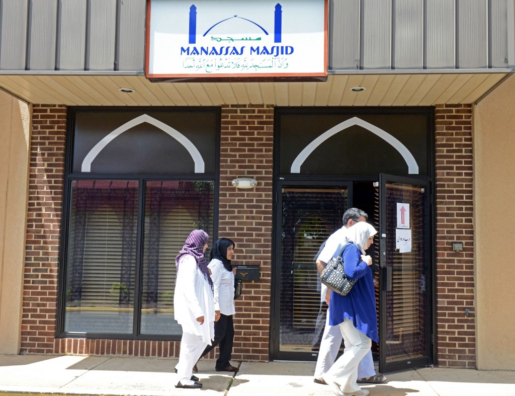 People pass one of the entrances of the Manassas Mosque in Manassas, Virginia.