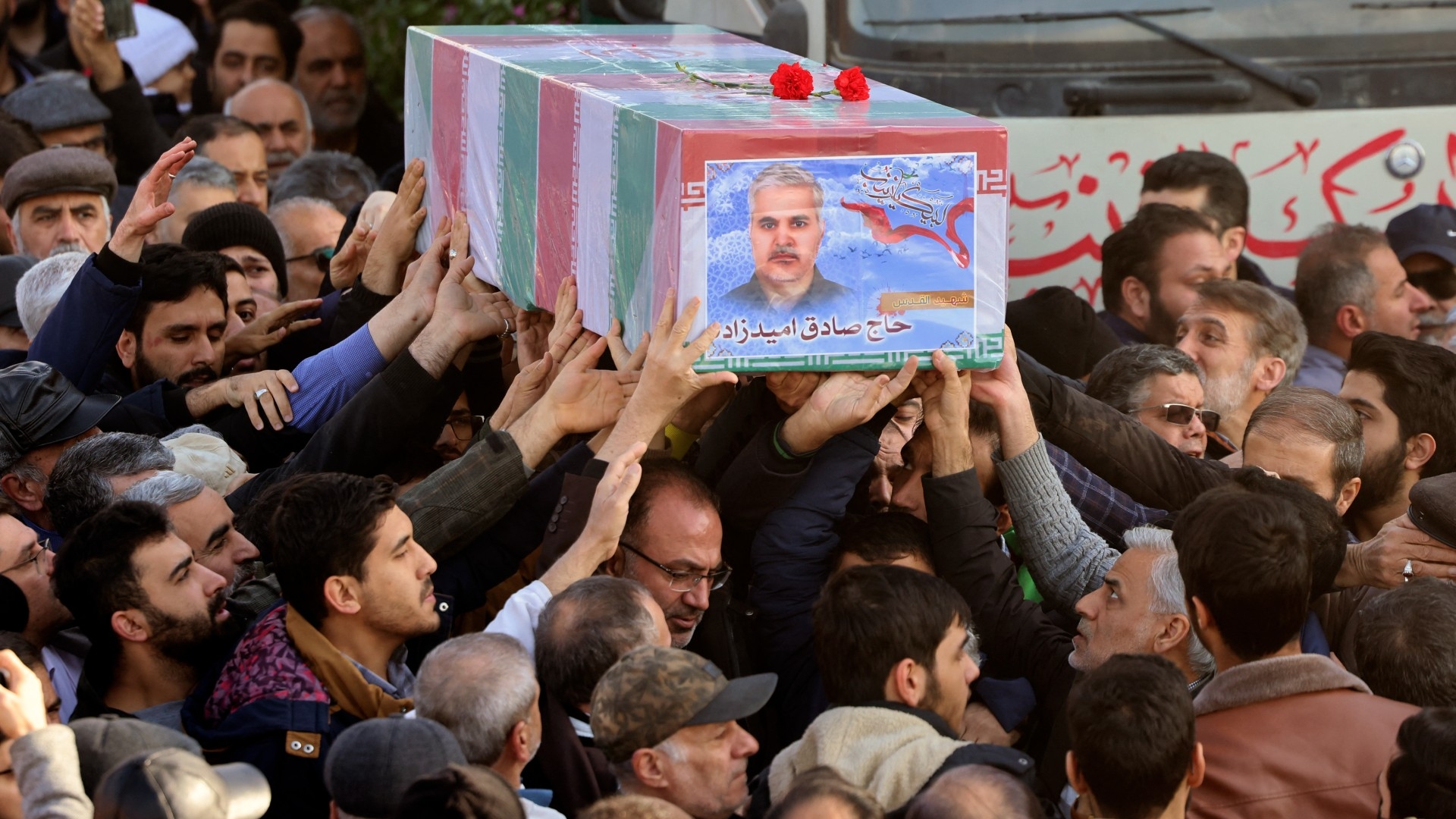 Mourners carry the casket of Islamic Revolutionary Guard Corps (IRGC) member, General Sadegh Omizadeh, killed in Damascus in a strike blamed on Israel on 20 January, during his funeral in Tehran on 22 January 2023 (Atta Kena/AFP)